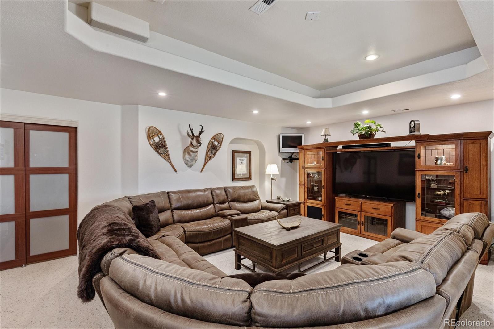 12080 Summit Ridge Road Parker, CO 80138 - Photo 28 of 39 a living room with furniture and a flat screen tv