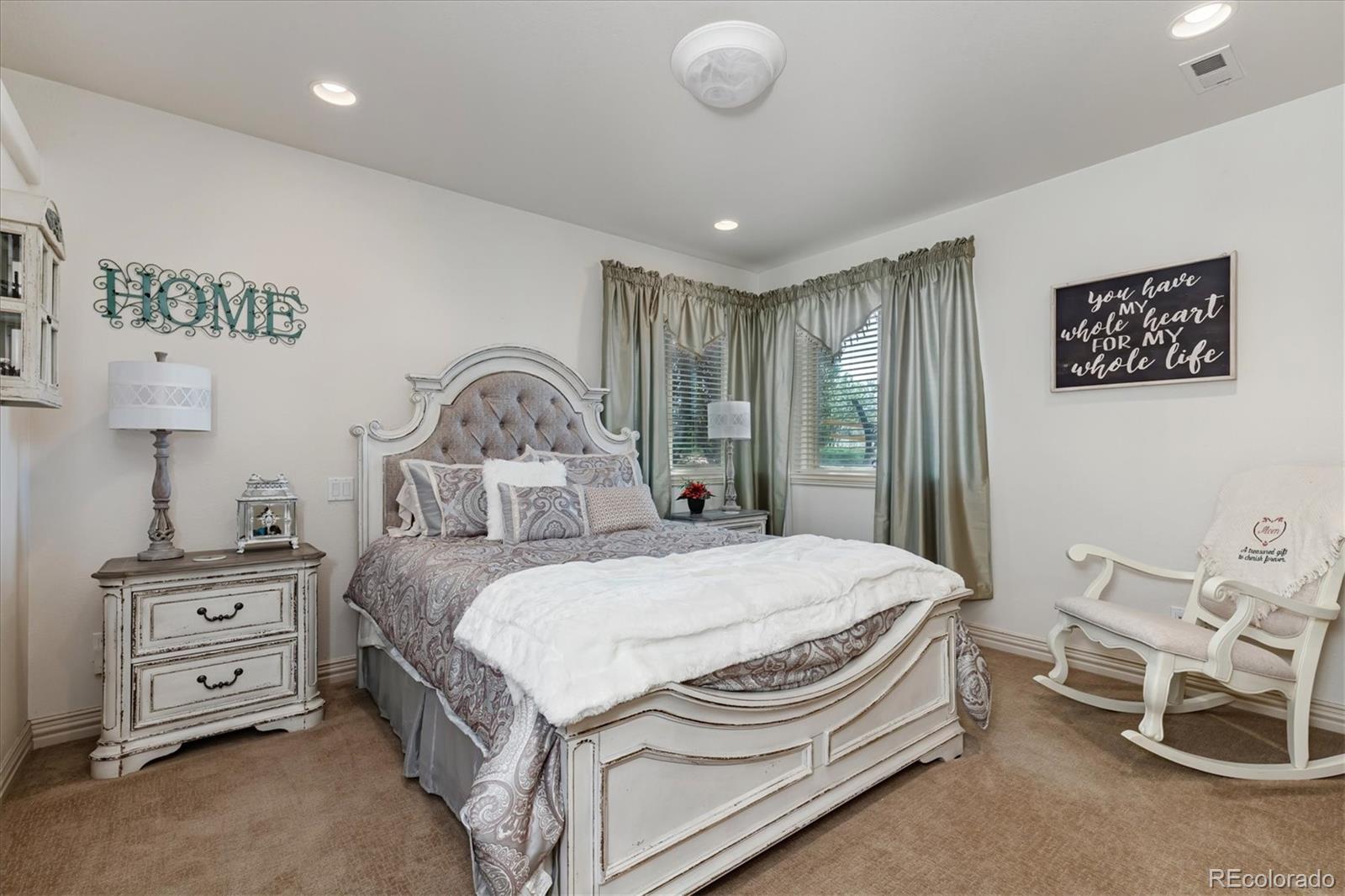 12080 Summit Ridge Road Parker, CO 80138 - Photo 32 of 39 a bedroom with a bed and a chandelier