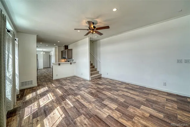 a view of a kitchen with a sink and a refrigerator