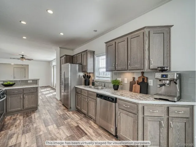 a view of a kitchen with a sink and refrigerator
