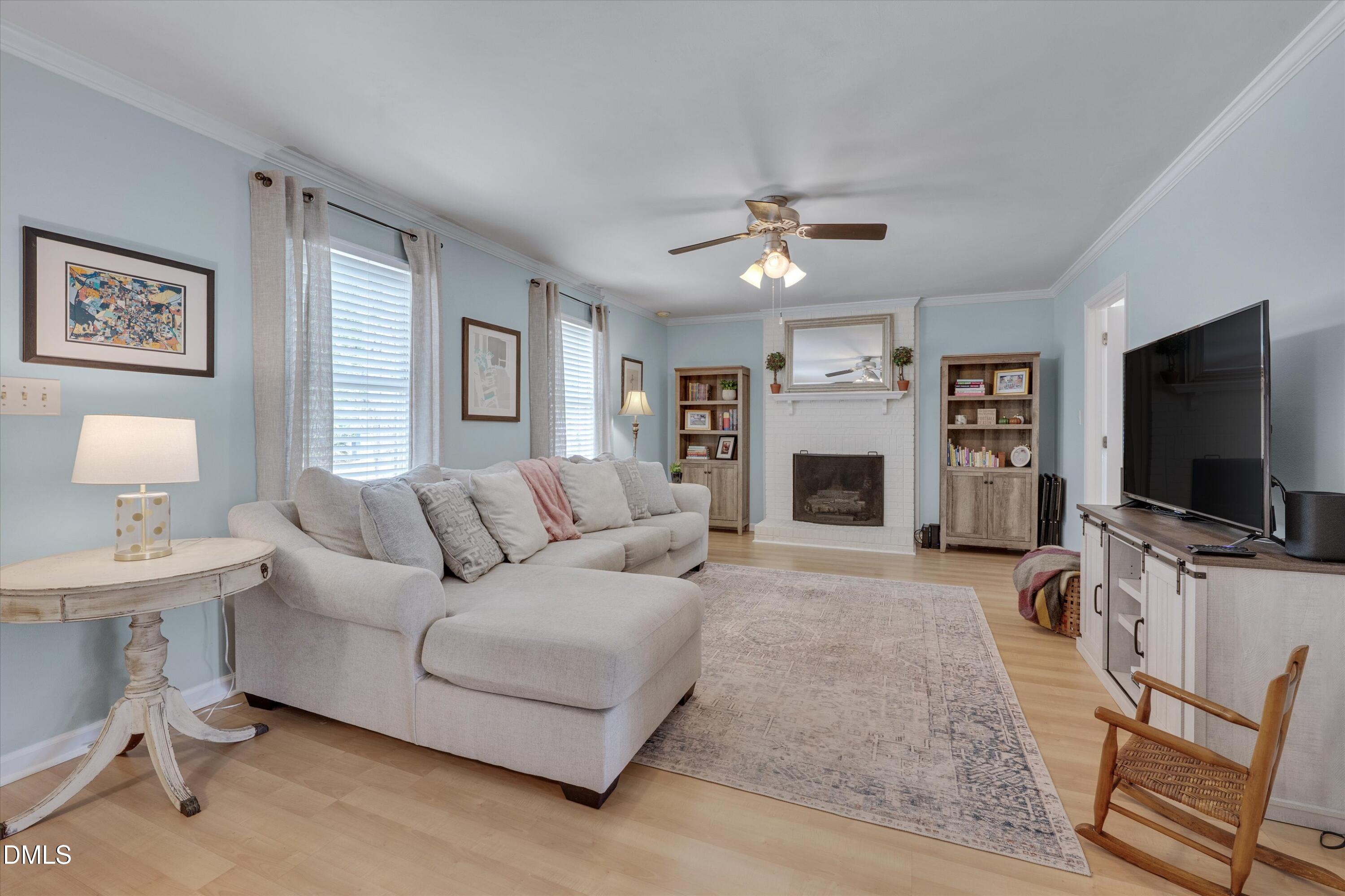 3301 Lassiter Street Durham, NC 27707 - Photo 5 of 32 a living room with furniture a flat screen tv and a fireplace