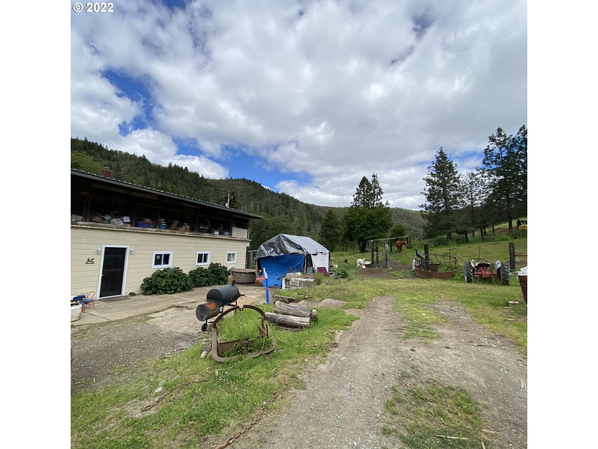 3005 Shoestring Road Riddle, OR 97469 - Photo 2 of 32 a view of a backyard with table and chairs