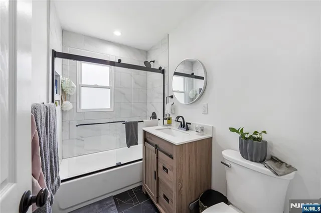 a bathroom with a sink a toilet and mirror