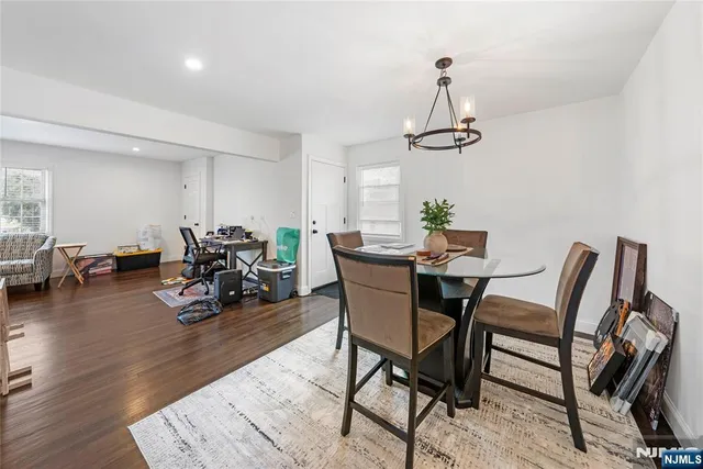 a view of a dining room with furniture wooden floor and chandelier