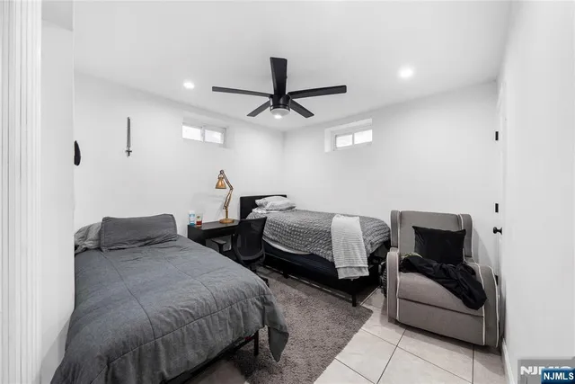 a bedroom with two beds and a couch