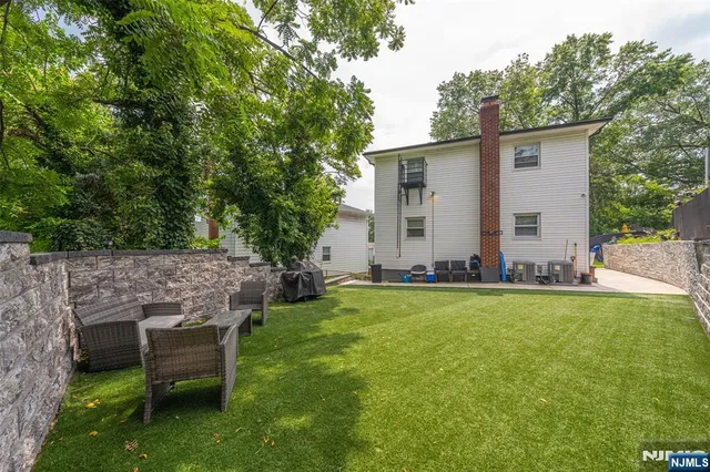 front view of a house with backyard and a garden