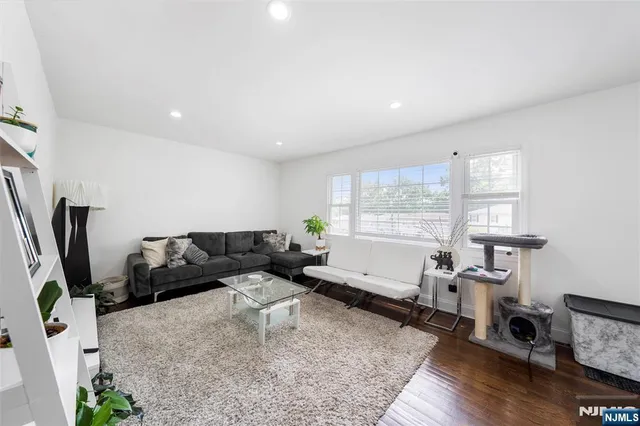 a living room with furniture window and wooden floor