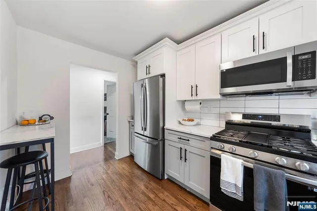 a kitchen with stainless steel appliances a refrigerator stove and microwave