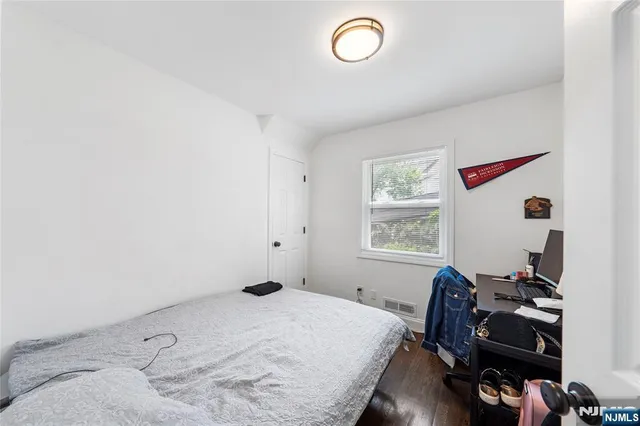 a bedroom with bed and a window