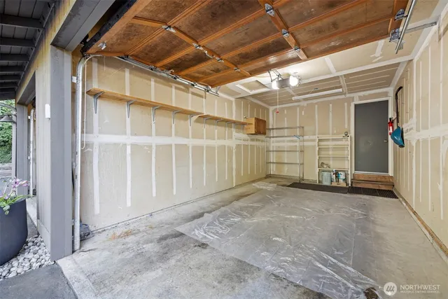 a view of backyard with a table and chairs and wooden fence