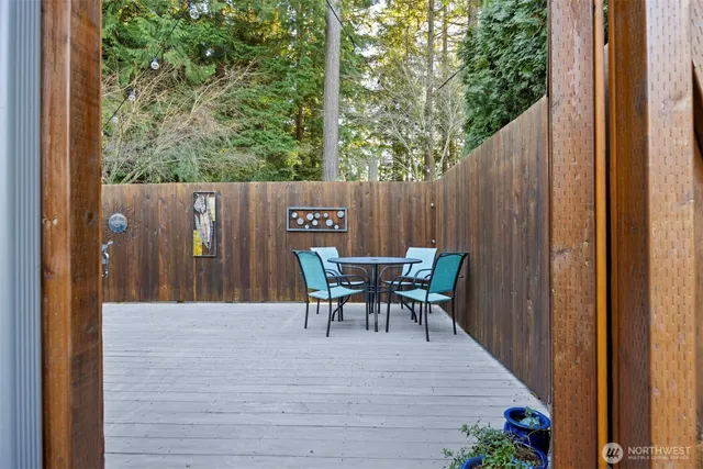 an aerial view of a house with a yard and large tree