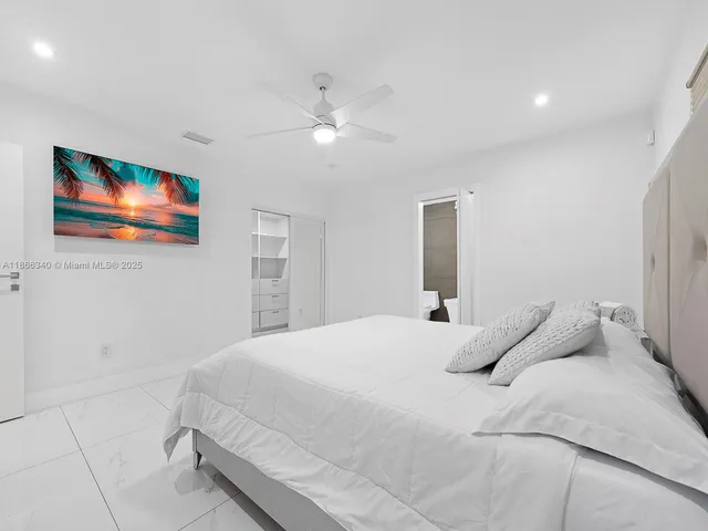 a bedroom with a bed and a painting on the wall