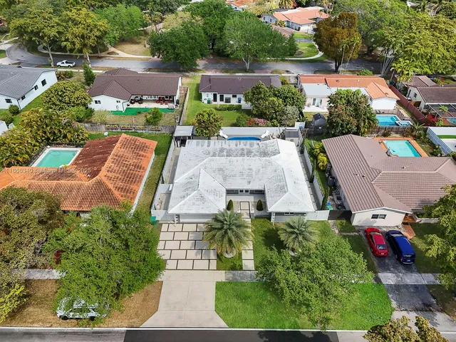 an aerial view of a house with a yard and outdoor seating