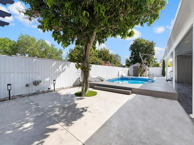 a view of swimming pool with seating space