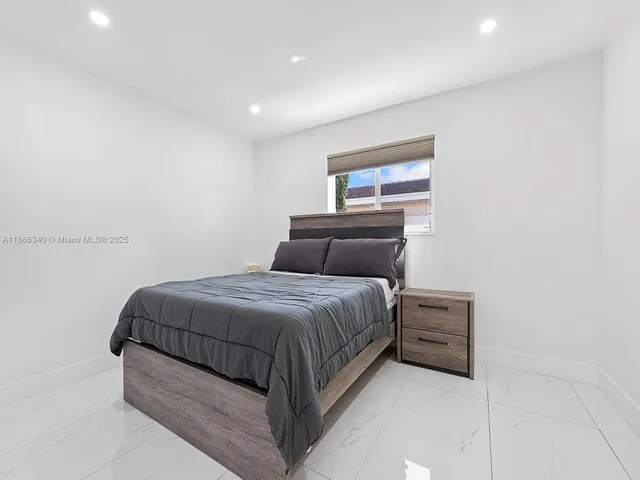 a bedroom with a bed and window