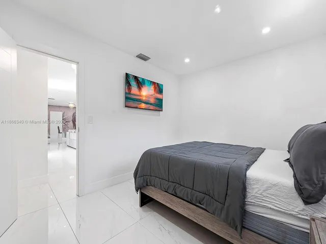 a bedroom with a bed and a painting on the wall