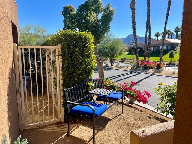 a view of a patio with table and chairs and potted plants