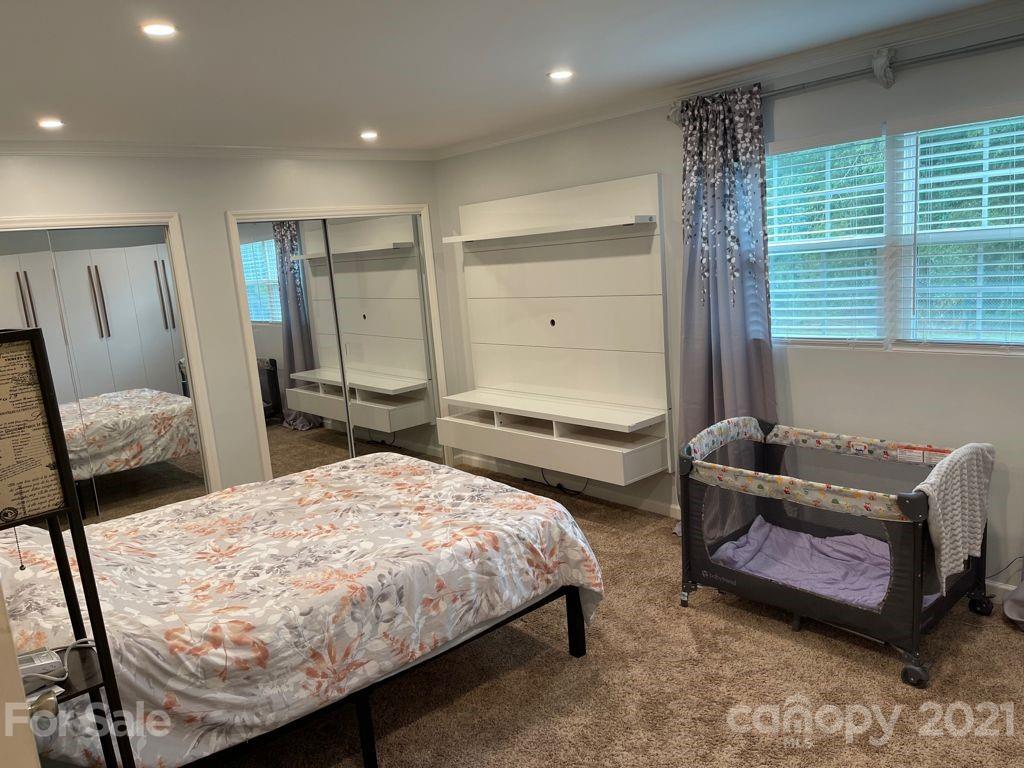 1803 Sim Williams Road Monroe, NC 28112 - Photo 8 of 12 a bedroom with a bed and a dresser