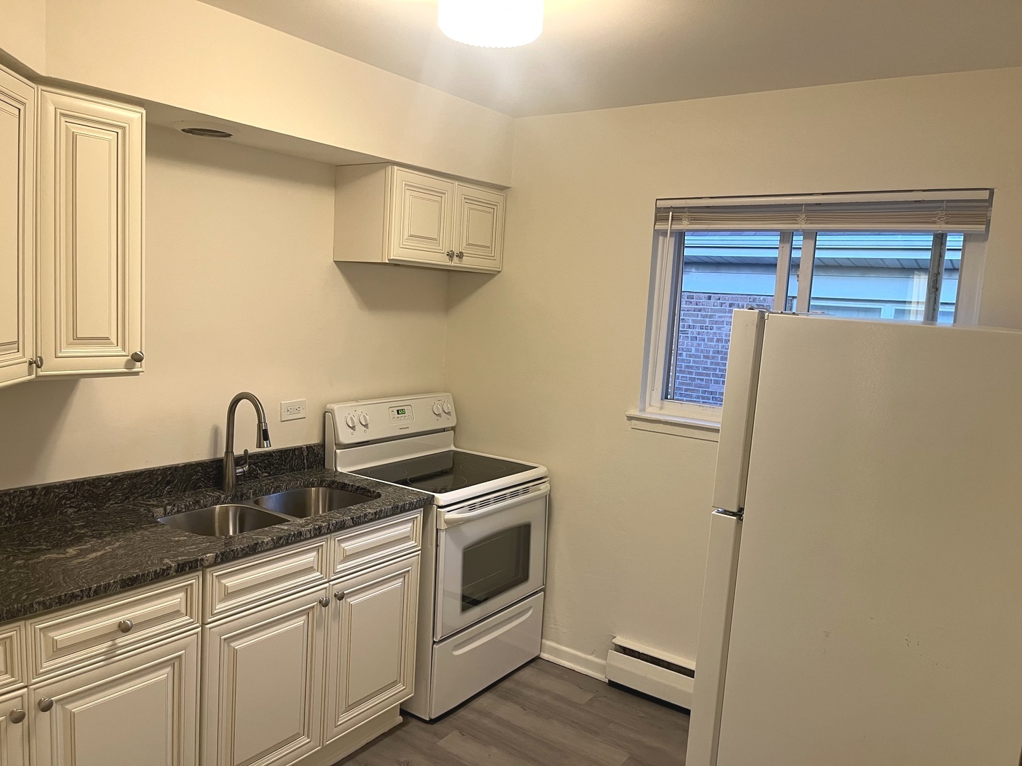 627 South Blanchard Street, Unit B3 Wheaton, IL 60187 - Photo 2 of 8 a kitchen with stainless steel appliances white cabinets and a sink