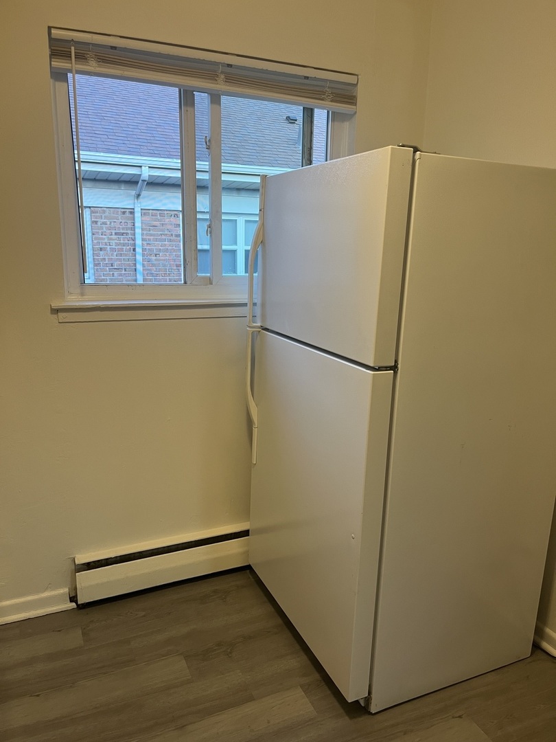 627 South Blanchard Street, Unit B3 Wheaton, IL 60187 - Photo 3 of 8 a white refrigerator freezer sitting in a kitchen