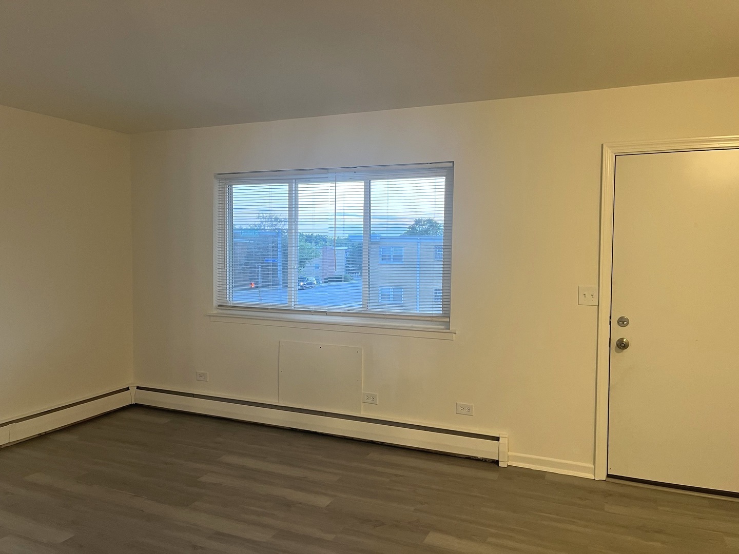 627 South Blanchard Street, Unit B3 Wheaton, IL 60187 - Photo 4 of 8 a view of an empty room with wooden floor and a window