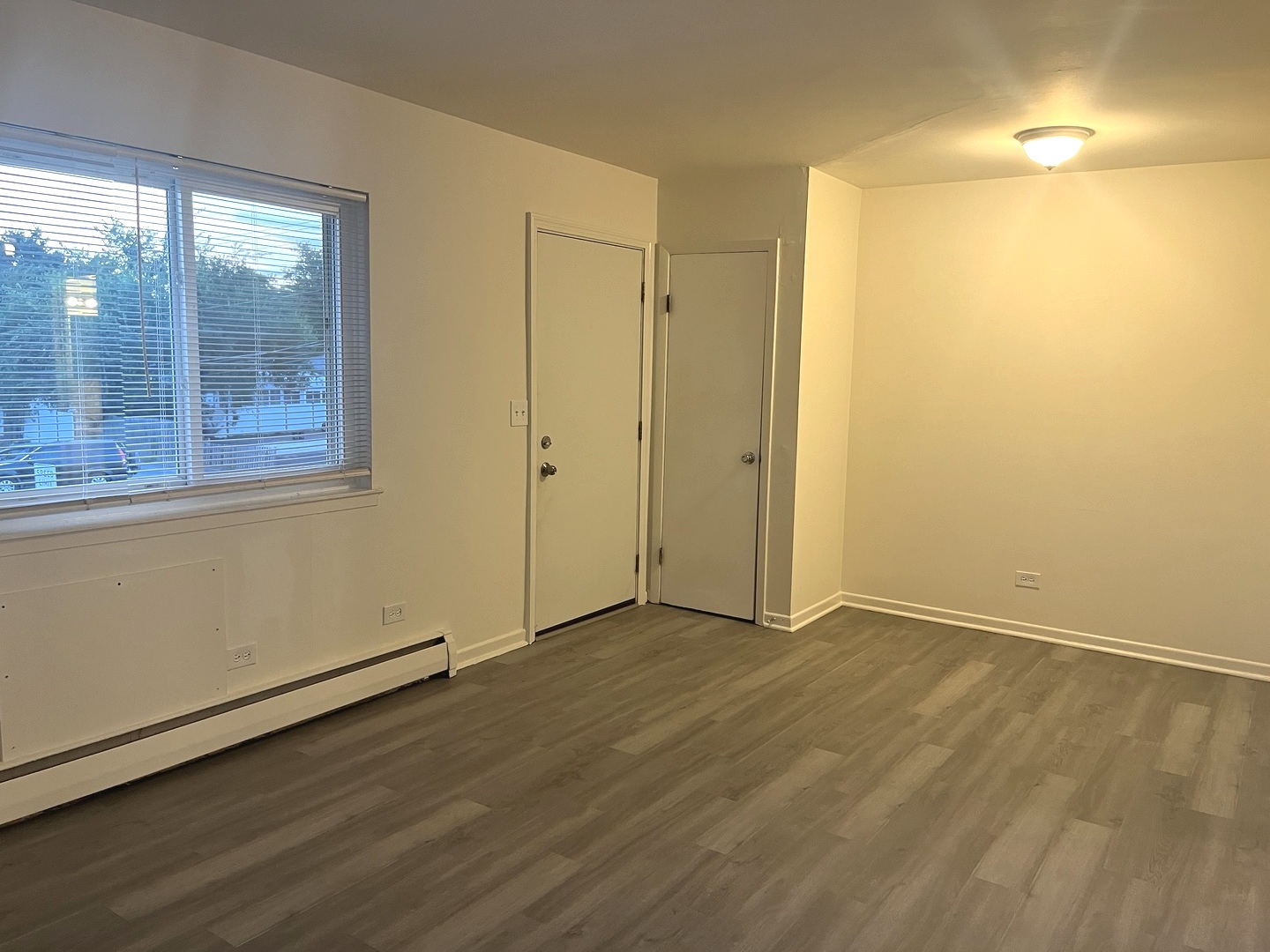 627 South Blanchard Street, Unit B3 Wheaton, IL 60187 - Photo 5 of 8 an empty room with wooden floor and windows