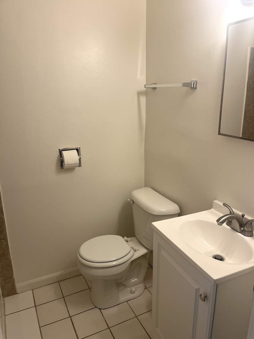 627 South Blanchard Street, Unit B3 Wheaton, IL 60187 - Photo 7 of 8 a white toilet sitting next to a bathroom sink