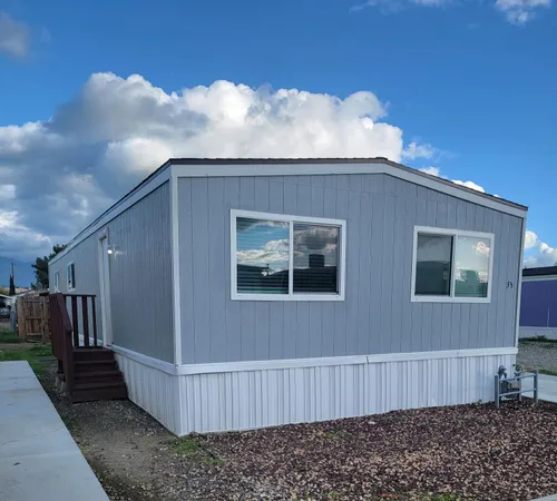a view of a house with backyard and wooden fence