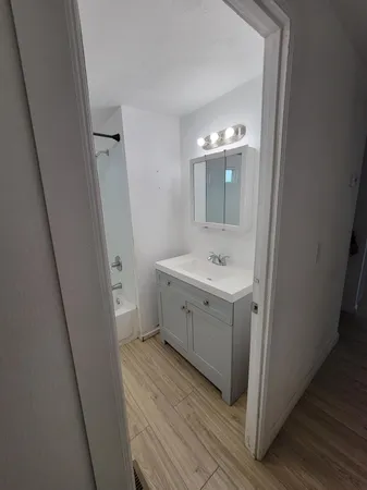 a bathroom with a double vanity sink and mirror