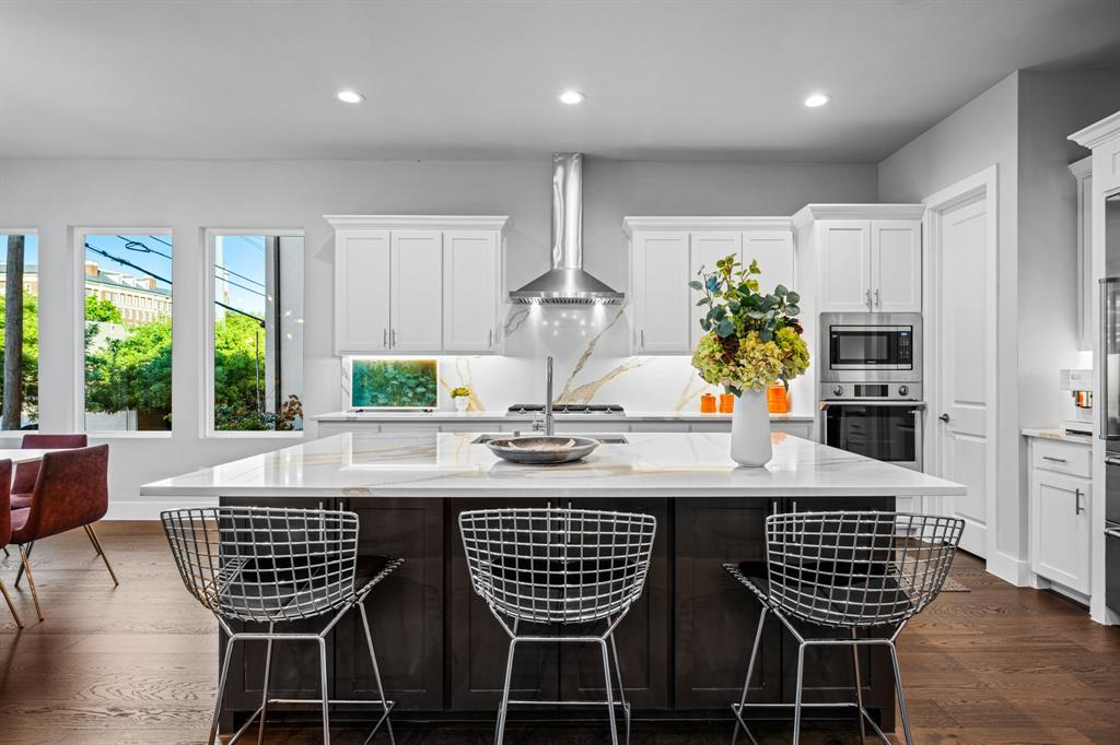 4138 Entrada Way Dallas, TX 75219 - Photo 14 of 40 a view of a dining room with furniture window and wooden floor