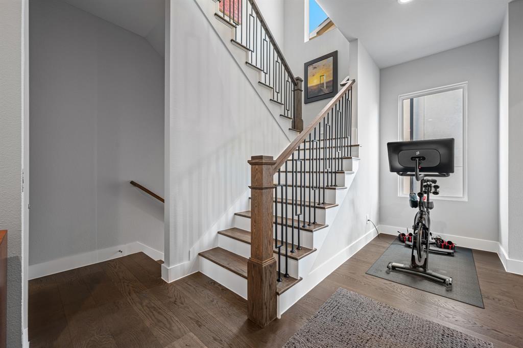 4138 Entrada Way Dallas, TX 75219 - Photo 16 of 40 a view of entryway with wooden floor and stairs