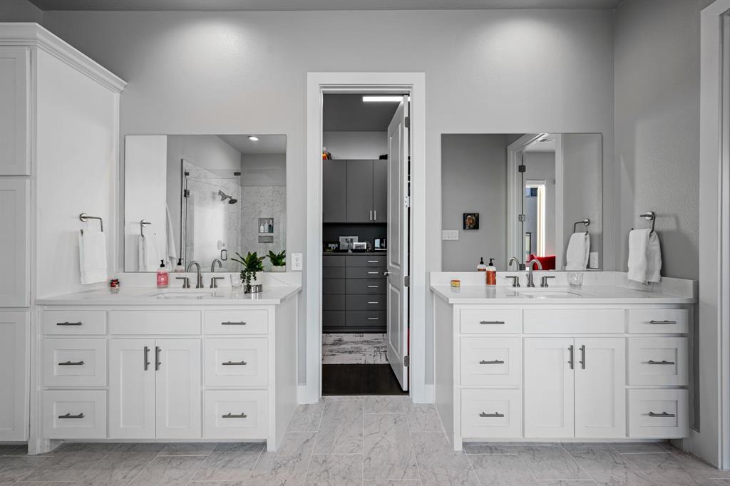 4138 Entrada Way Dallas, TX 75219 - Photo 20 of 40 a spacious bathroom with a double vanity sink and a mirror