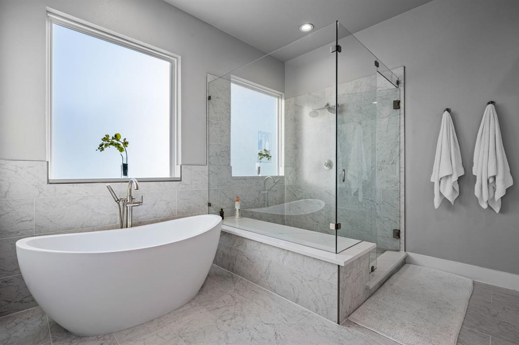 4138 Entrada Way Dallas, TX 75219 - Photo 21 of 40 a white bath tub sitting next to a shower