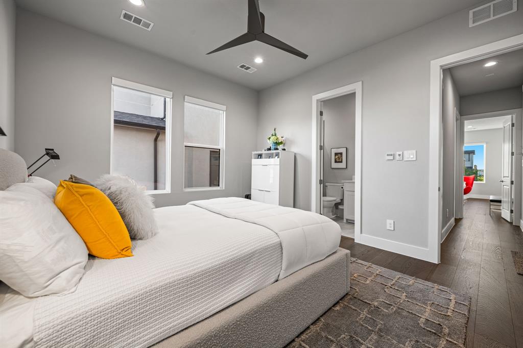 4138 Entrada Way Dallas, TX 75219 - Photo 24 of 40 a bedroom with a bed and a chandelier