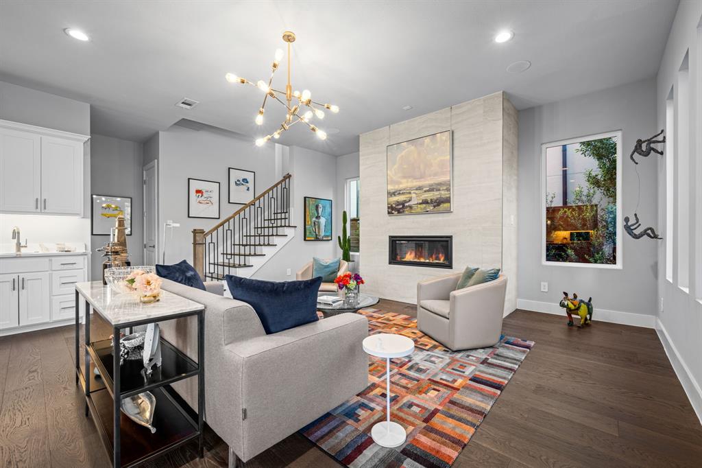 4138 Entrada Way Dallas, TX 75219 - Photo 7 of 40 a living room with fireplace furniture and a wooden floor