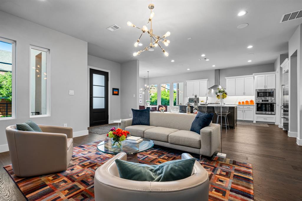 4138 Entrada Way Dallas, TX 75219 - Photo 9 of 40 a living room with furniture and a chandelier