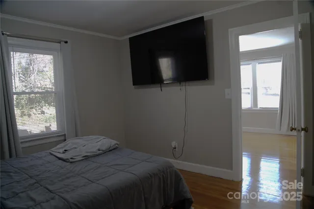 a bedroom with a bed and a flat screen tv
