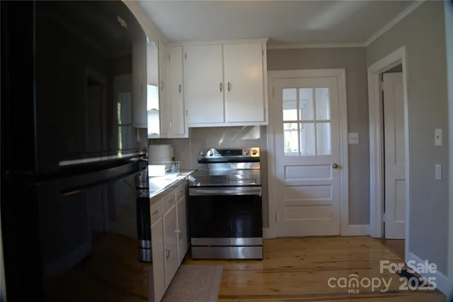 a kitchen with granite countertop a stove and a refrigerator