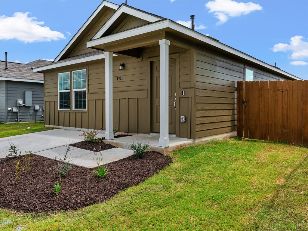 13911 Mussel Run Elgin, TX 78621 - Photo 1 of 1 a front view of a house with garden