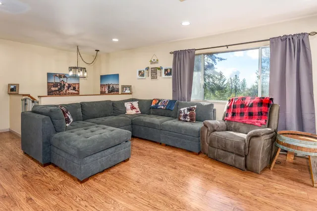 a dining room with furniture and wooden floor