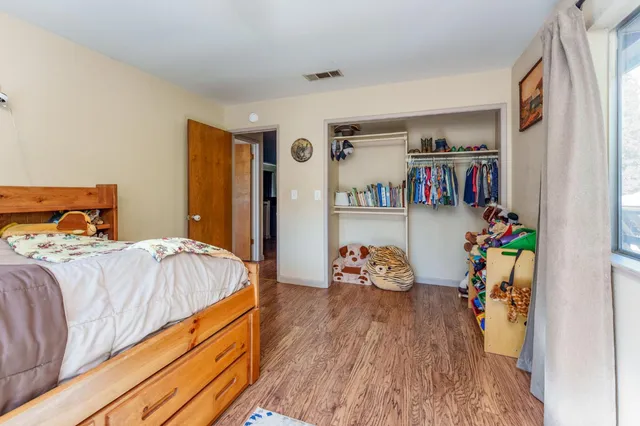 a bedroom with furniture and a window