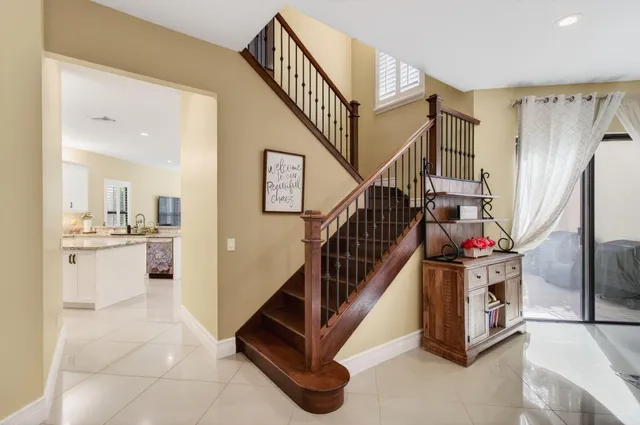 a bathroom with a granite countertop sink a toilet a mirror a vanity a bath tub and shower