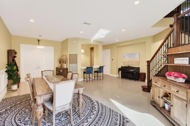 an aerial view of residential houses with outdoor space and trees