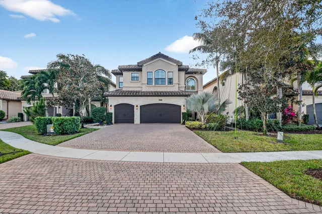 a kitchen with stainless steel appliances granite countertop a sink and a refrigerator