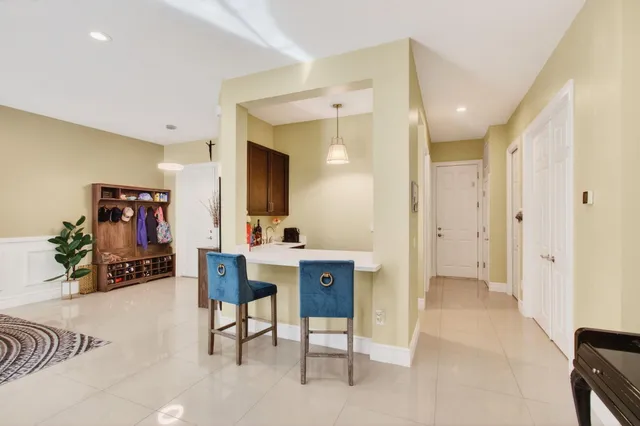 a bedroom with a bed and a lamp on the dresser