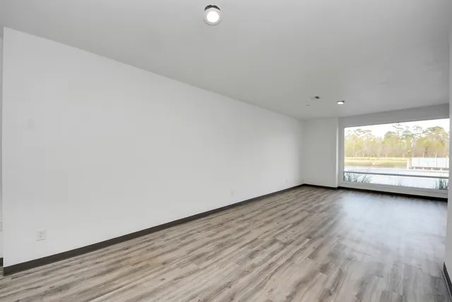 a view of wooden floor and windows in a room