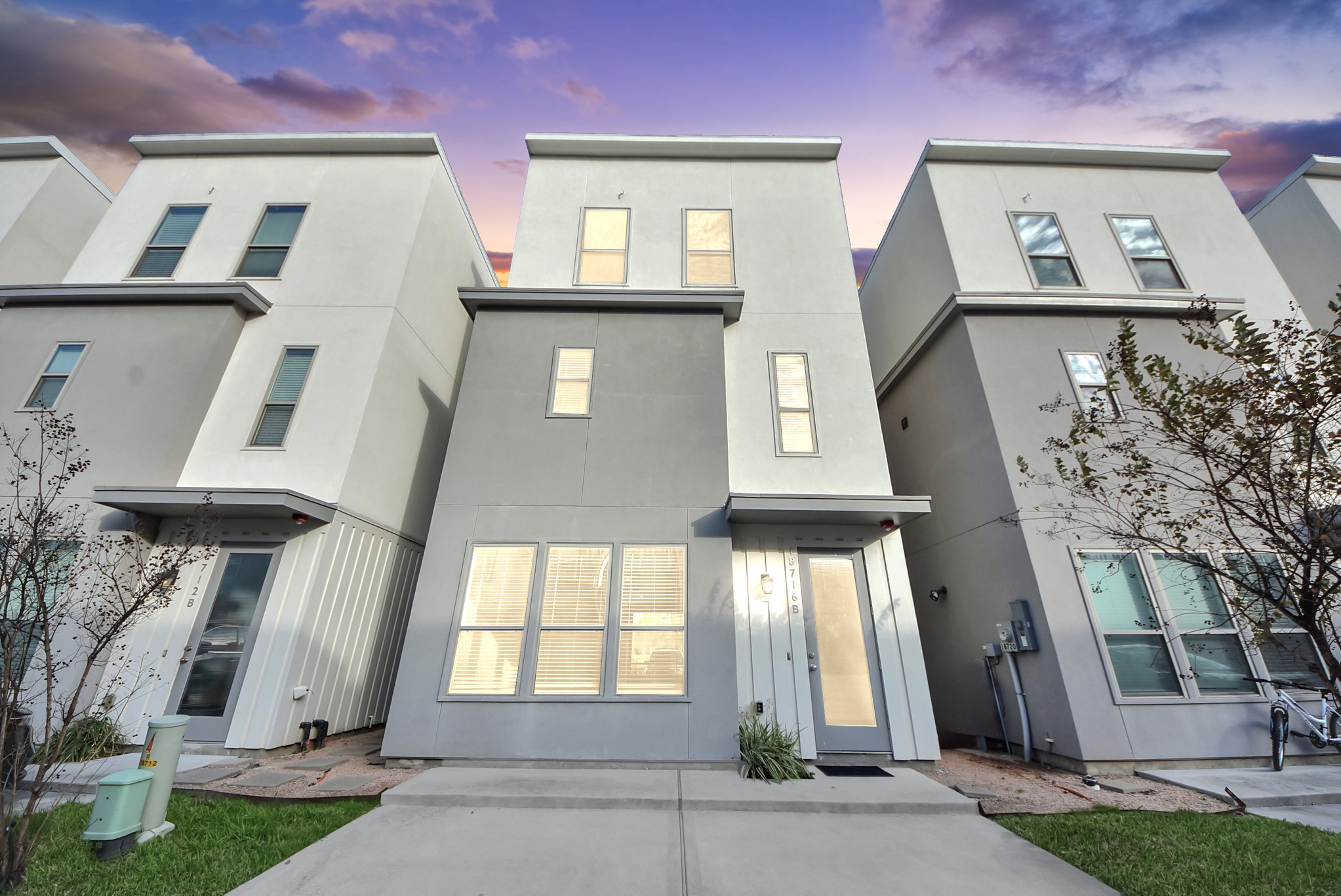 18716 Centro Main Street Conroe, TX 77385 - Photo 15 of 50 Street-facing exterior view highlighting modern Centro architecture and the separate residential entrance to the upper-level living space. Digitally Enhanced.