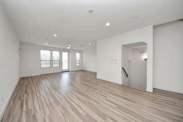 a view of kitchen with wooden floor and electronic appliances