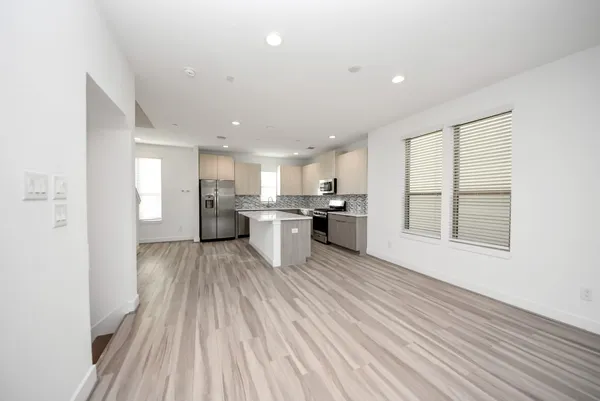 a view of kitchen with wooden floor and electronic appliances