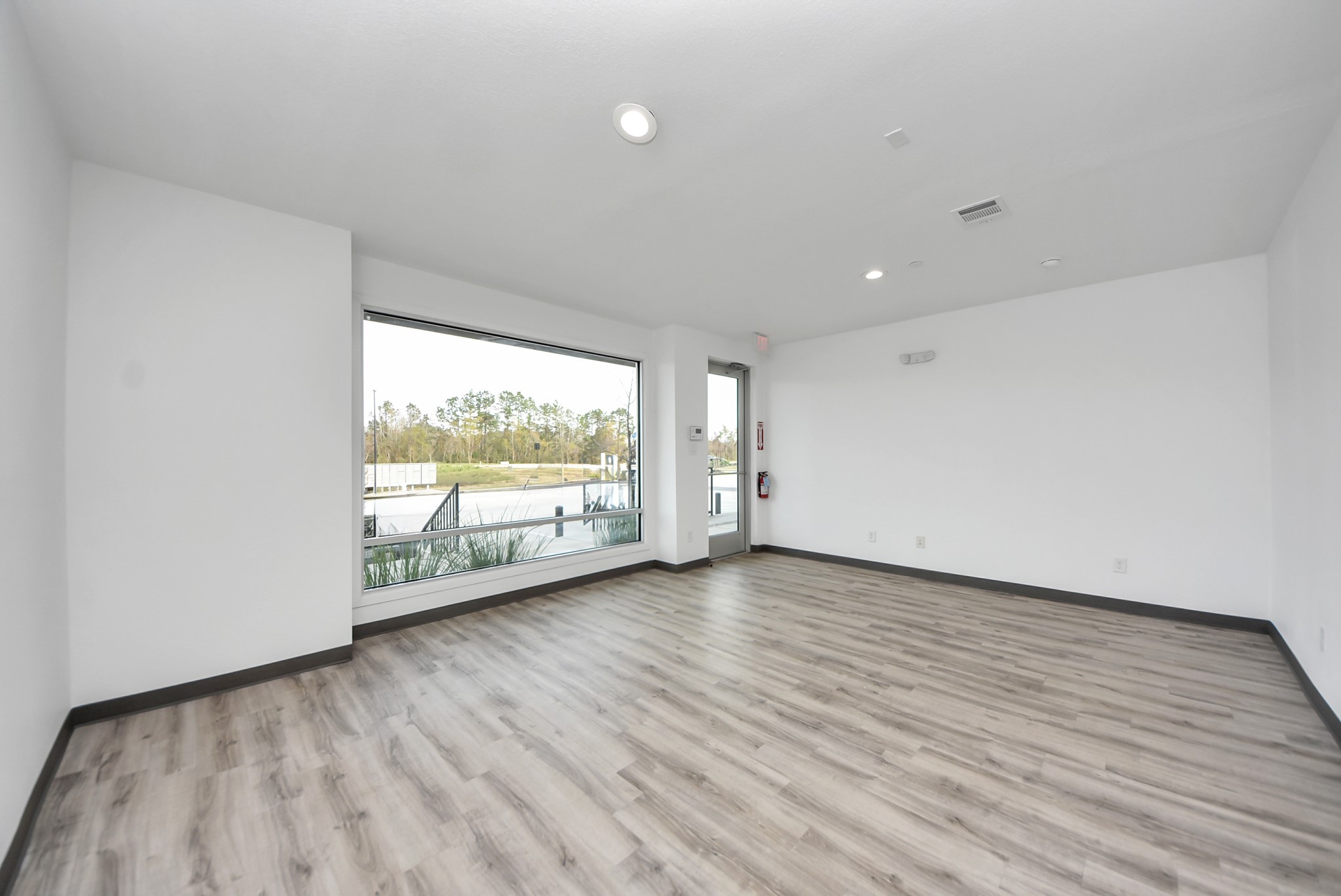 18716 Centro Main Street Conroe, TX 77385 - Photo 3 of 50 Bright workspace with large street-facing window offering strong visibility, natural light, and signage exposure.